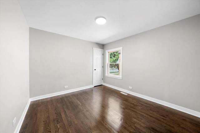 unfurnished room with dark hardwood / wood-style floors