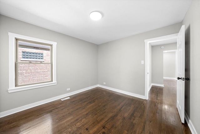 empty room with dark hardwood / wood-style floors