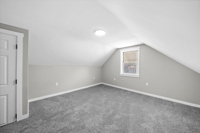 bonus room featuring carpet flooring and vaulted ceiling