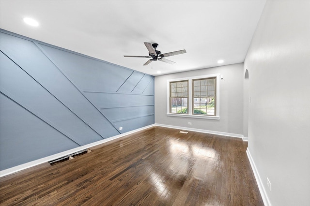 empty room featuring ceiling fan and dark hardwood / wood-style floors