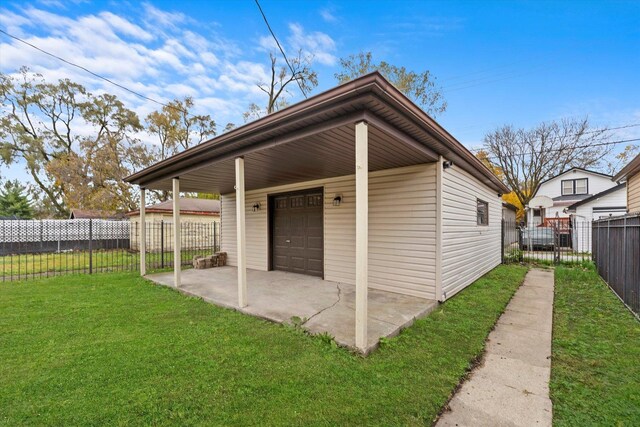 view of outdoor structure with a yard and a garage