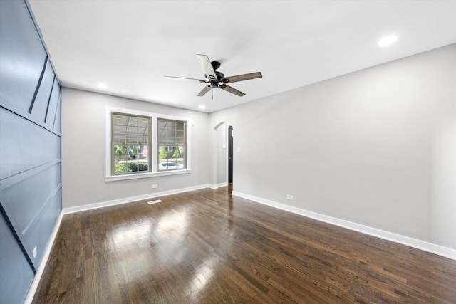 empty room featuring ceiling fan and dark hardwood / wood-style floors