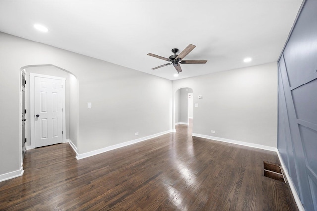 spare room featuring ceiling fan and dark hardwood / wood-style floors