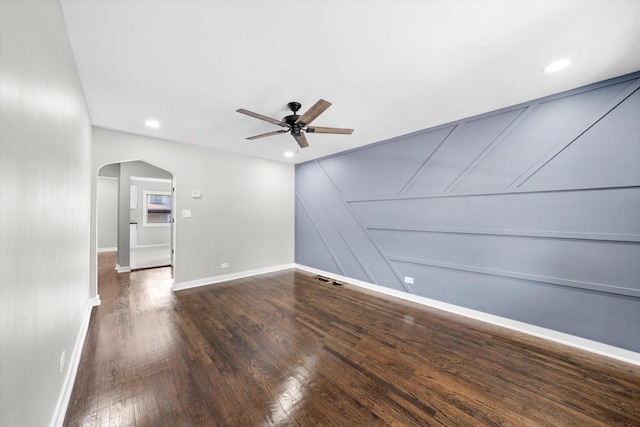 empty room featuring dark hardwood / wood-style flooring and ceiling fan