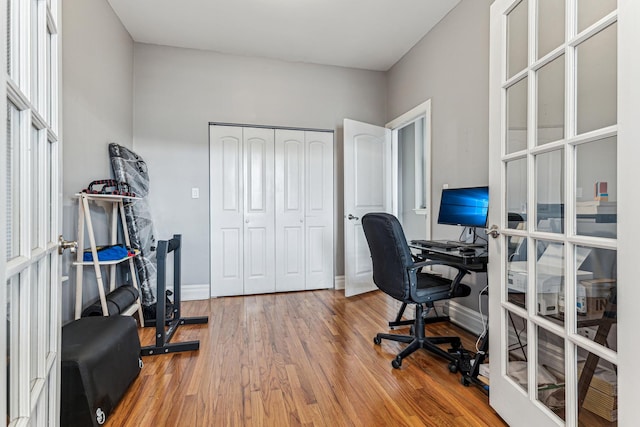 home office featuring french doors and hardwood / wood-style floors