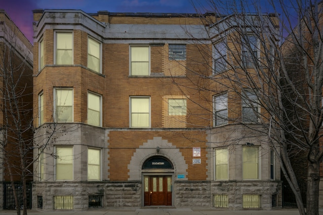 view of outdoor building at dusk