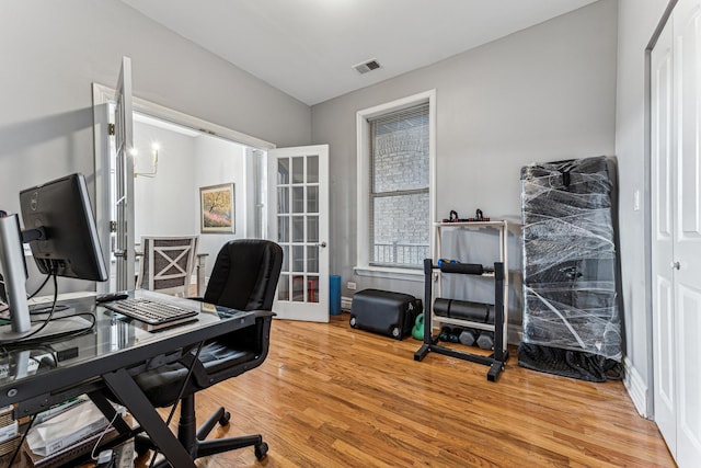 office featuring wood-type flooring and french doors