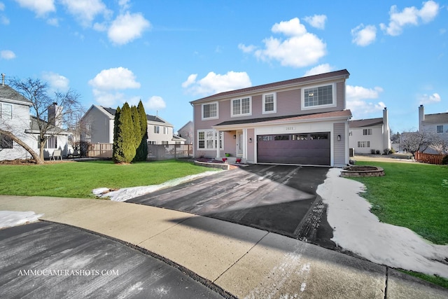 view of front of home featuring a garage and a front lawn