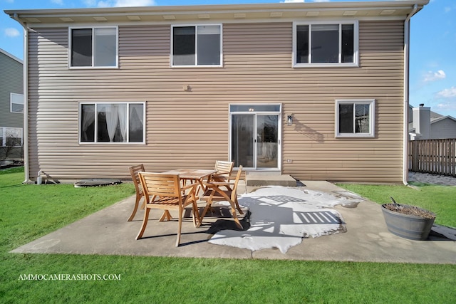 rear view of property featuring a patio and a lawn