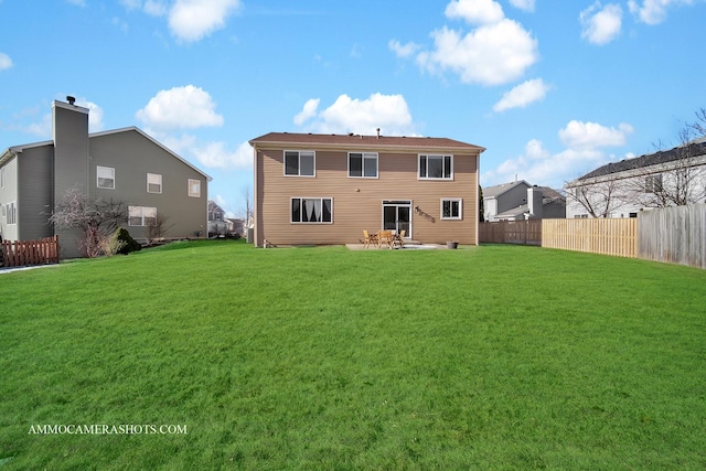 rear view of house featuring a patio and a lawn