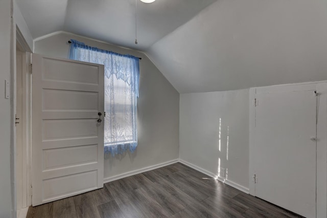 additional living space featuring lofted ceiling and dark hardwood / wood-style floors