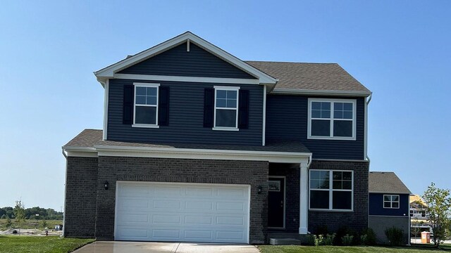 view of front of home featuring a garage and a front lawn