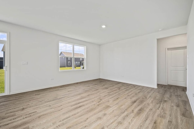 spare room featuring light wood-type flooring