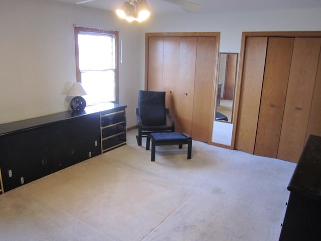 sitting room with light carpet and ceiling fan