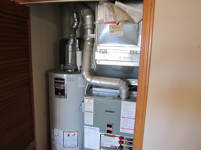 utility room featuring gas water heater