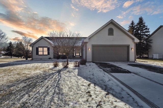 ranch-style home featuring a garage and central AC