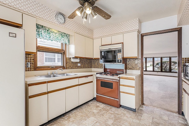 627 Paxton Ave, Calumet City, IL 60409 - kitchen with range with gas cooktop, a ceiling fan, and light countertops