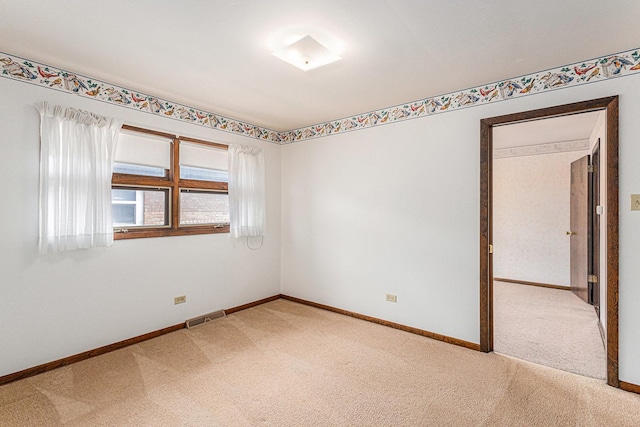 627 Paxton Ave, Calumet City, IL 60409 - spare room with baseboards, visible vents, and light colored carpet