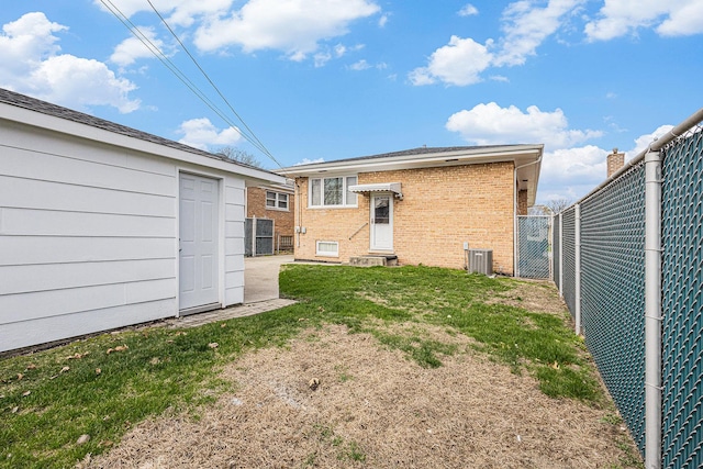 627 Paxton Ave, Calumet City, IL 60409 - back of property with an outbuilding, a fenced backyard, brick siding, entry steps, and a lawn