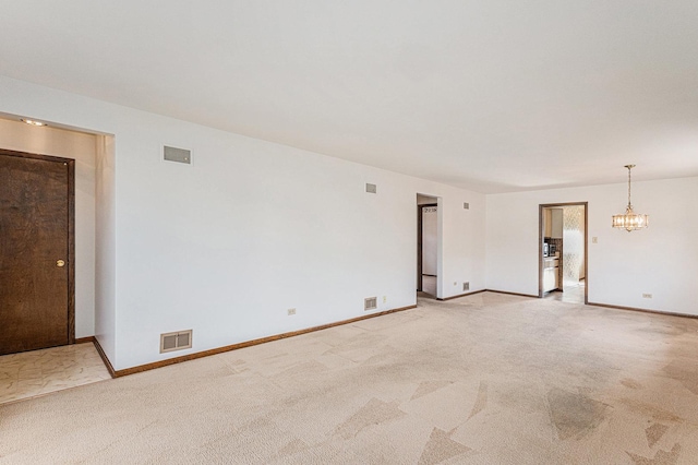 627 Paxton Ave, Calumet City, IL 60409 - spare room featuring light carpet, a notable chandelier, and visible vents