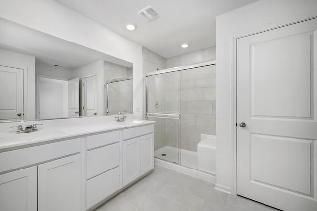 bathroom featuring vanity, tile patterned floors, and walk in shower