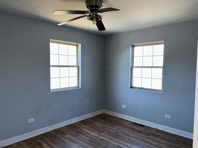 unfurnished room featuring dark wood-type flooring and ceiling fan