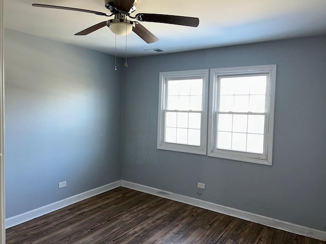 unfurnished room with dark hardwood / wood-style floors and ceiling fan