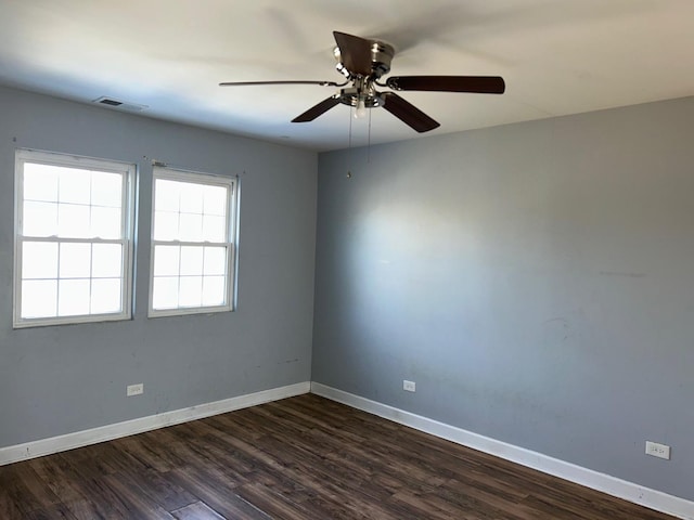 unfurnished room with dark hardwood / wood-style floors and ceiling fan