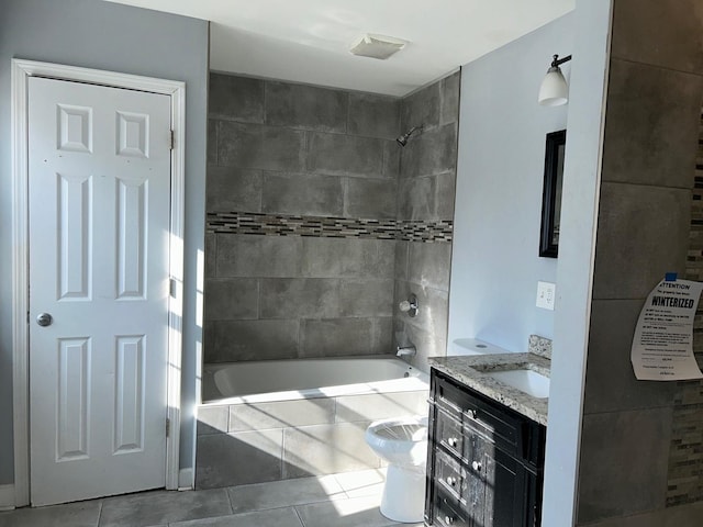 full bathroom featuring vanity, tile patterned flooring, toilet, and tiled shower / bath combo