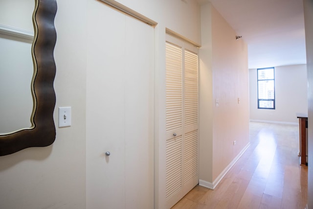 corridor with light hardwood / wood-style flooring