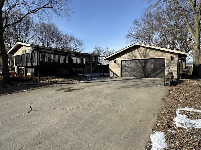 exterior space with a garage and a wooden deck