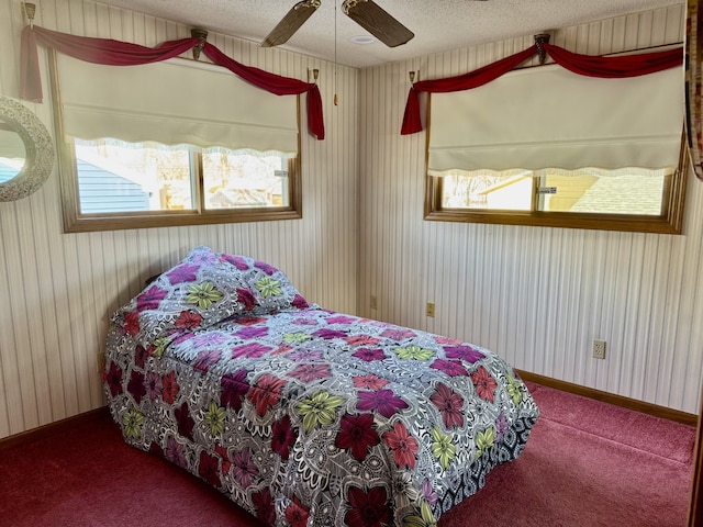 bedroom featuring ceiling fan, a textured ceiling, and carpet