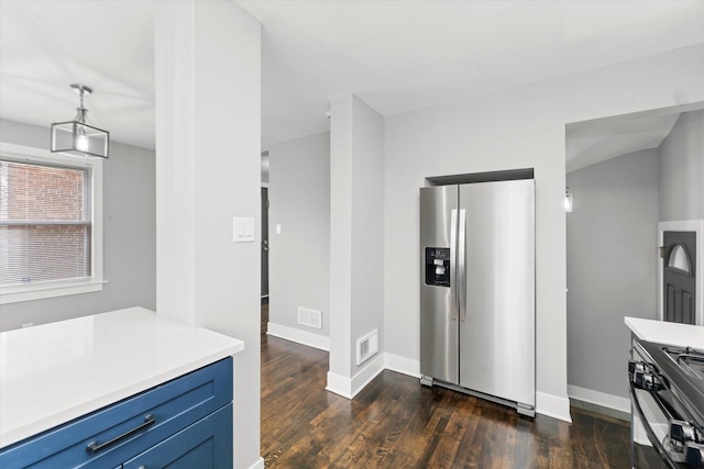 kitchen with dark wood-type flooring, appliances with stainless steel finishes, and blue cabinets