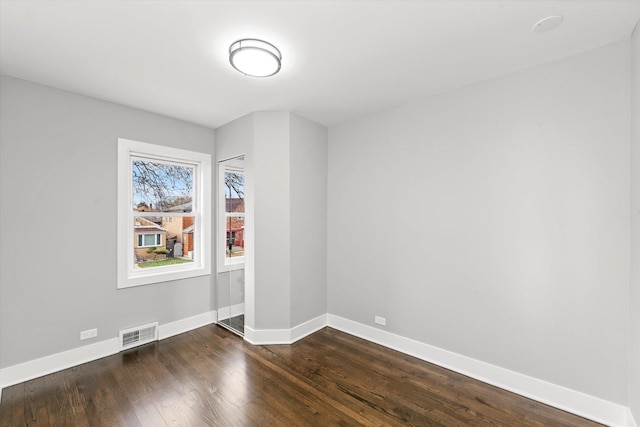 spare room featuring dark hardwood / wood-style flooring