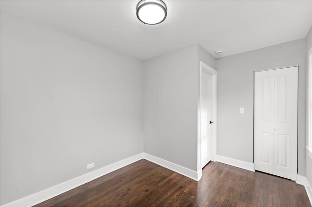 unfurnished room featuring dark wood-type flooring