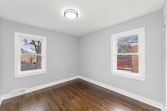 empty room featuring dark hardwood / wood-style flooring