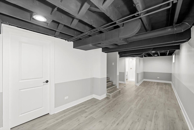 basement with hardwood / wood-style flooring