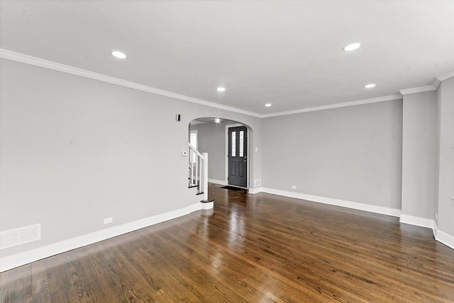 empty room with crown molding and dark hardwood / wood-style floors