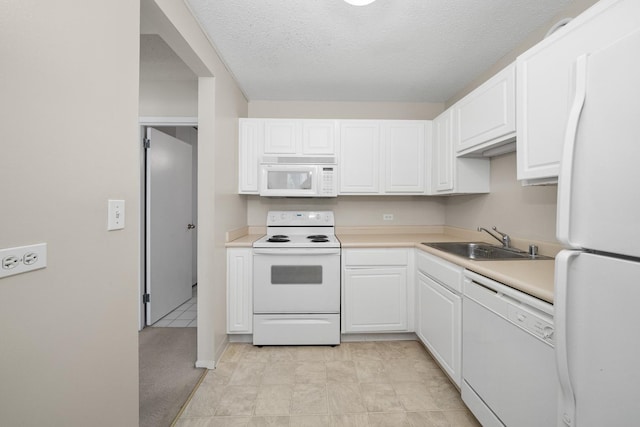 kitchen with white cabinetry, white appliances, sink, and a textured ceiling