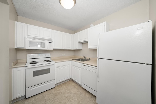 kitchen with white cabinetry, white appliances, sink, and a textured ceiling