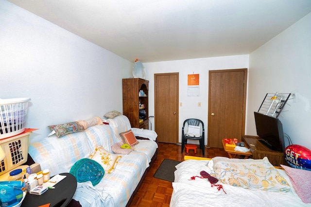 bedroom with dark parquet flooring