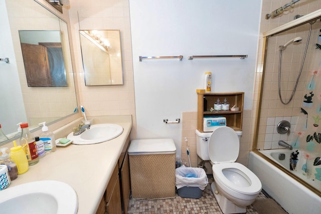 full bathroom with vanity, bath / shower combo with glass door, and toilet