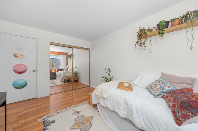 bedroom with hardwood / wood-style floors and a closet