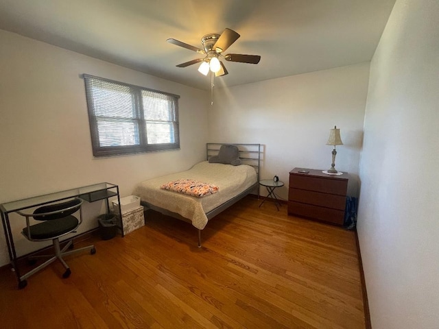 bedroom featuring wood finished floors and a ceiling fan