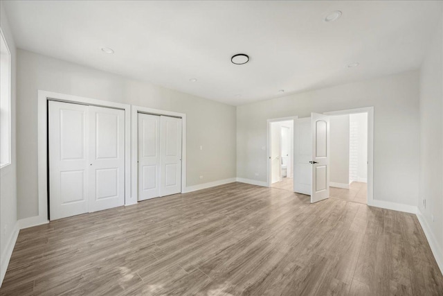 unfurnished bedroom with light wood-type flooring