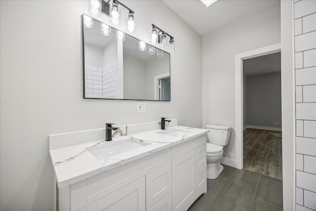 bathroom featuring vanity and toilet