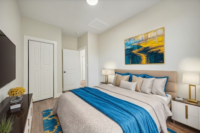 bedroom featuring hardwood / wood-style floors and a closet