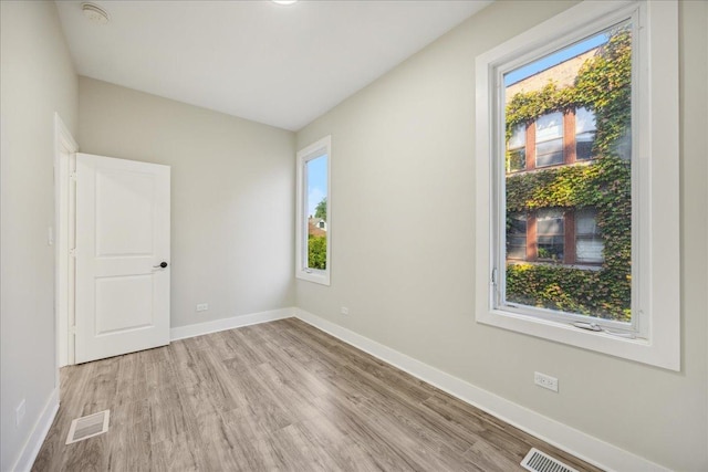 unfurnished room featuring light hardwood / wood-style floors