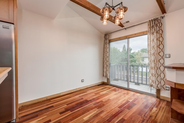 interior space featuring wood-type flooring, lofted ceiling with beams, and a chandelier