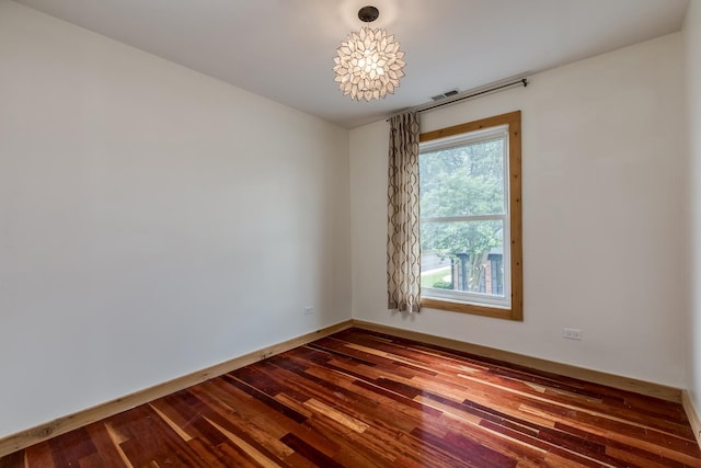 spare room featuring wood-type flooring